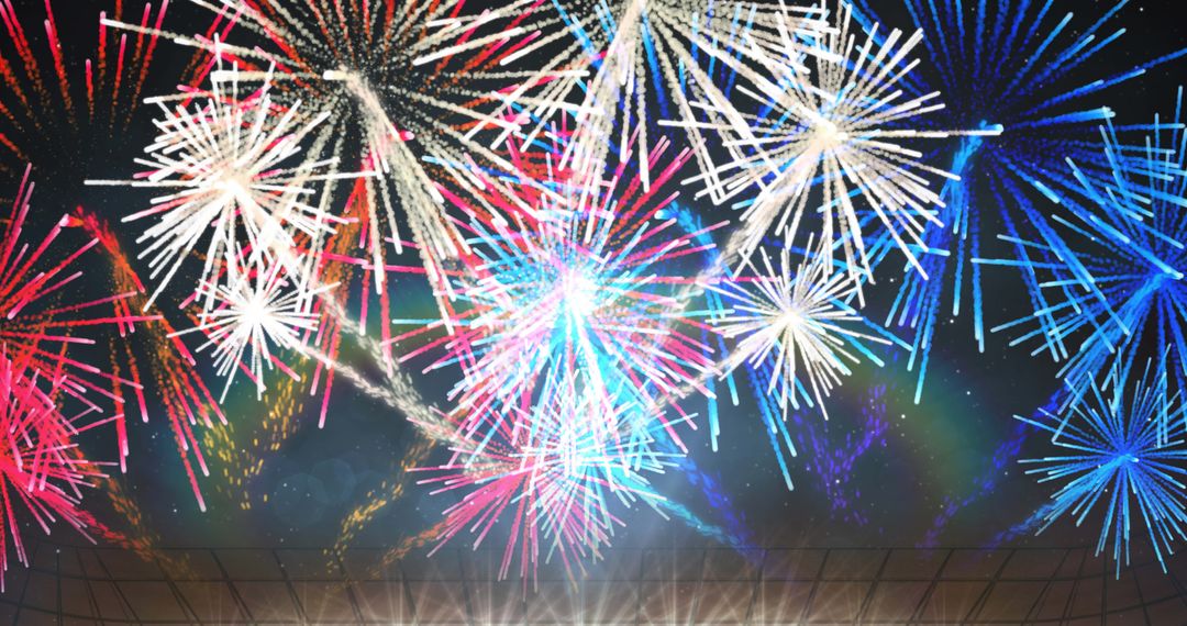 Vibrant Fireworks Display Bathed in Colorful Spotlights