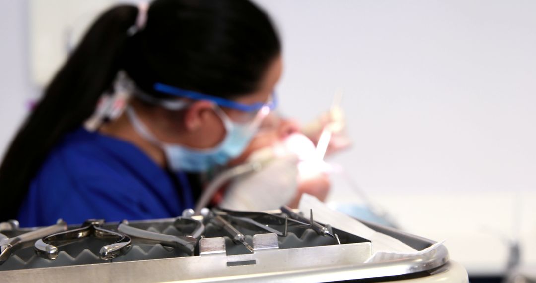 Dentist Treating Patient, Dental Tools in Foreground - Free Images, Stock Photos and Pictures on Pikwizard.com