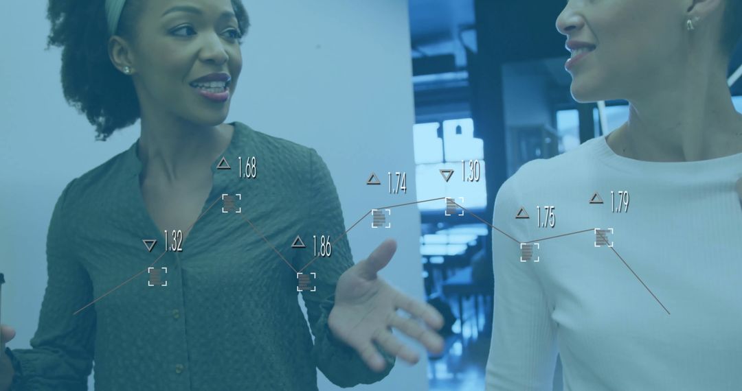 Female Colleagues Analyzing Data in Modern Office Environment