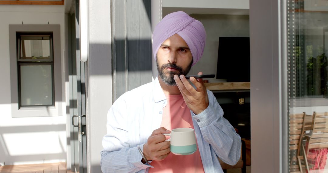 Man in Turban Communicating via Smartphone at Home