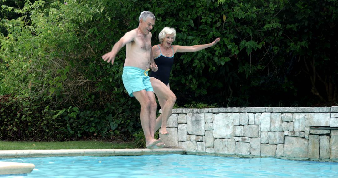 Happy Senior Couple Jumping into Swimming Pool Outdoors - Free Images, Stock Photos and Pictures on Pikwizard.com