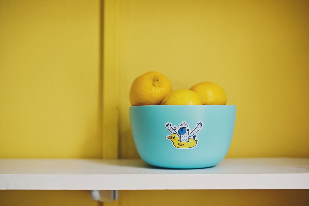 Blue Bowl with Lemons against Bright Yellow Background - Free Images, Stock Photos and Pictures on Pikwizard.com