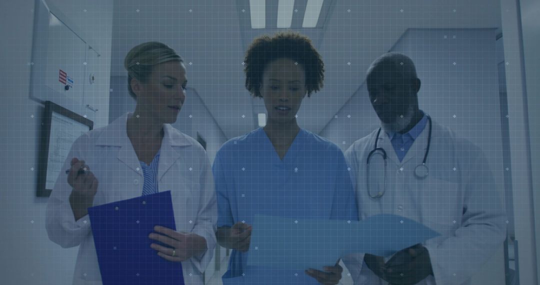Medical Team Discusses Patient Chart in Hospital Corridor