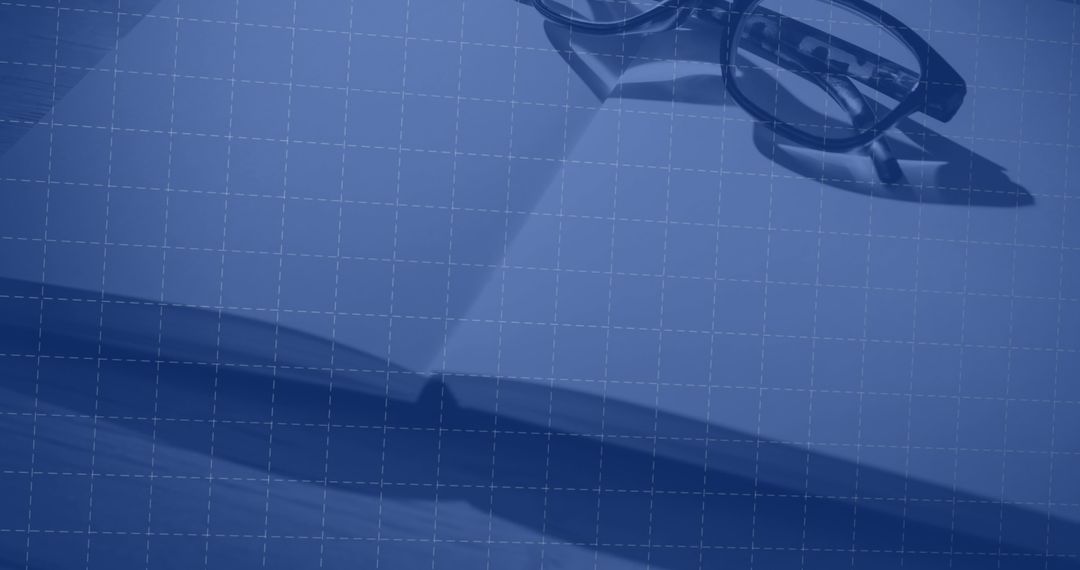Stylish Glasses on Open Notebook with Grid Overlay for Creative Professional Setup