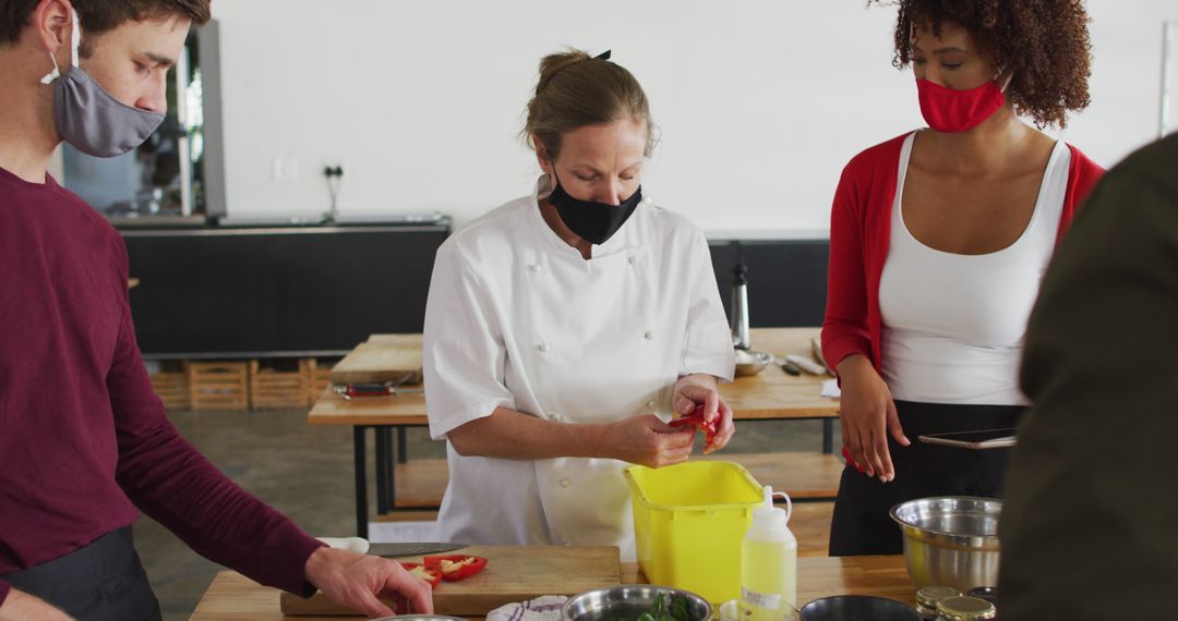 Chef Leading Cooking Class with Diverse Team Wearing Face Masks - Free Images, Stock Photos and Pictures on Pikwizard.com