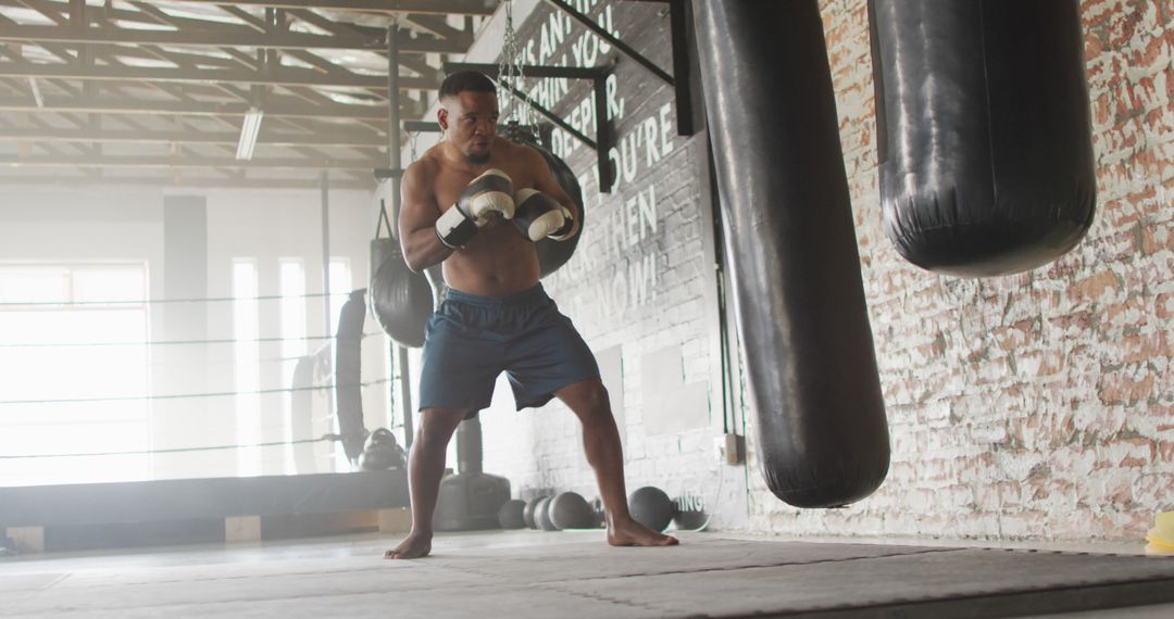 Image of fit african american man boxing at gym - Free Images, Stock Photos and Pictures on Pikwizard.com