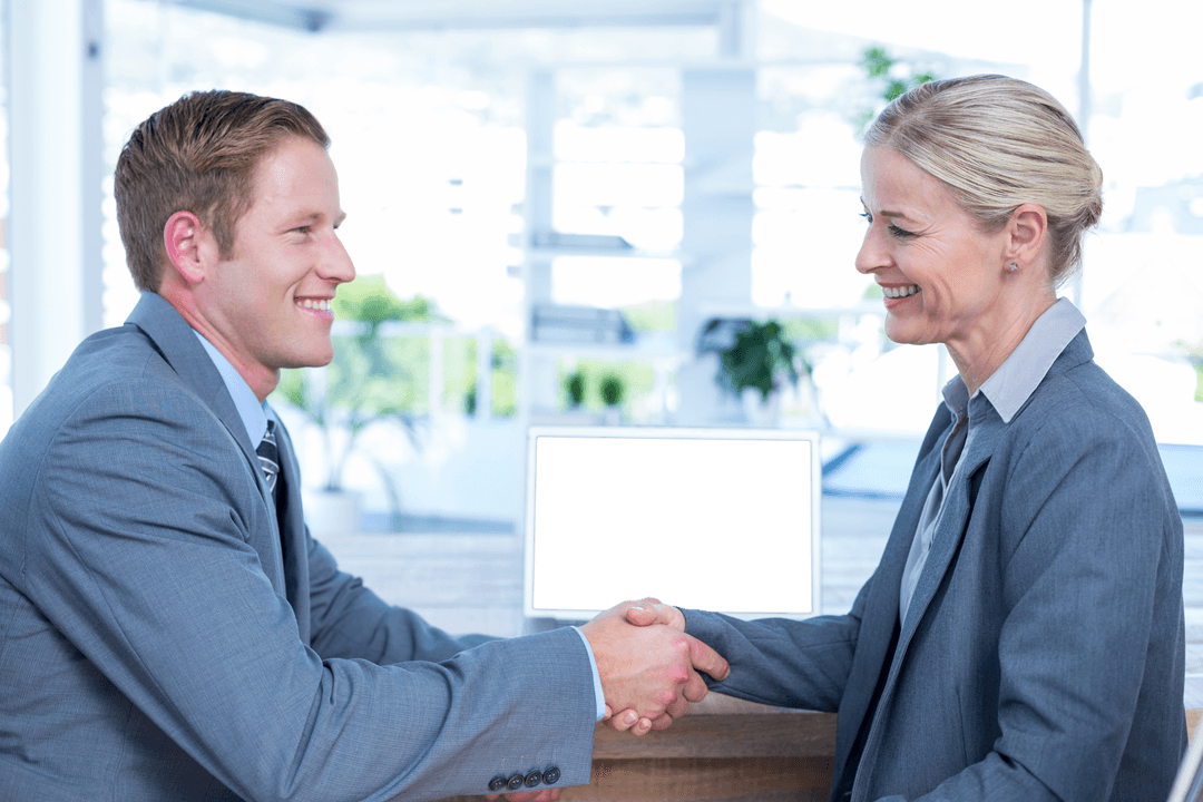 Transparent Business Colleagues Shaking Hands in a Bright Office