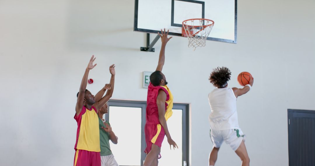 Young Athletes Playing Dynamic Indoor Basketball Game