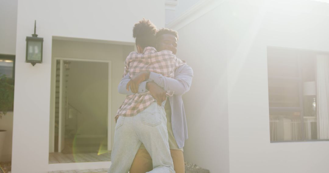 Image of happy african american couple embracing in front of new house - Free Images, Stock Photos and Pictures on Pikwizard.com