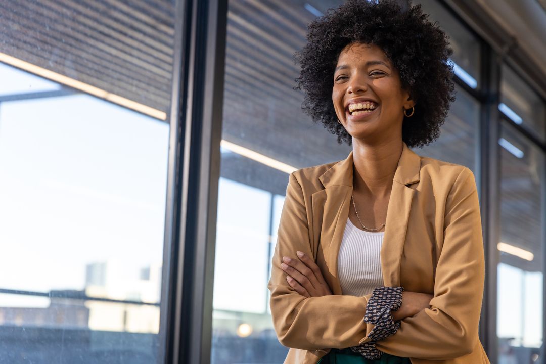 Confident Businesswoman Smiling in Modern Office Corridor