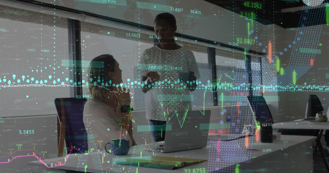 Businesswomen Discussing Financial Data in Modern Office Environment