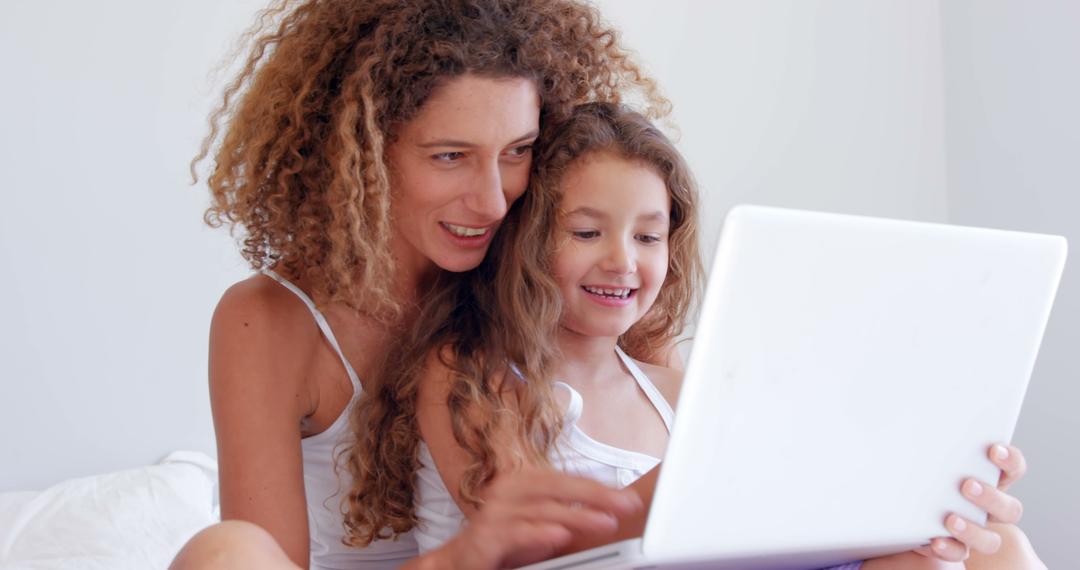 Smiling Mother and Daughter Using Laptop Together - Free Images, Stock Photos and Pictures on Pikwizard.com