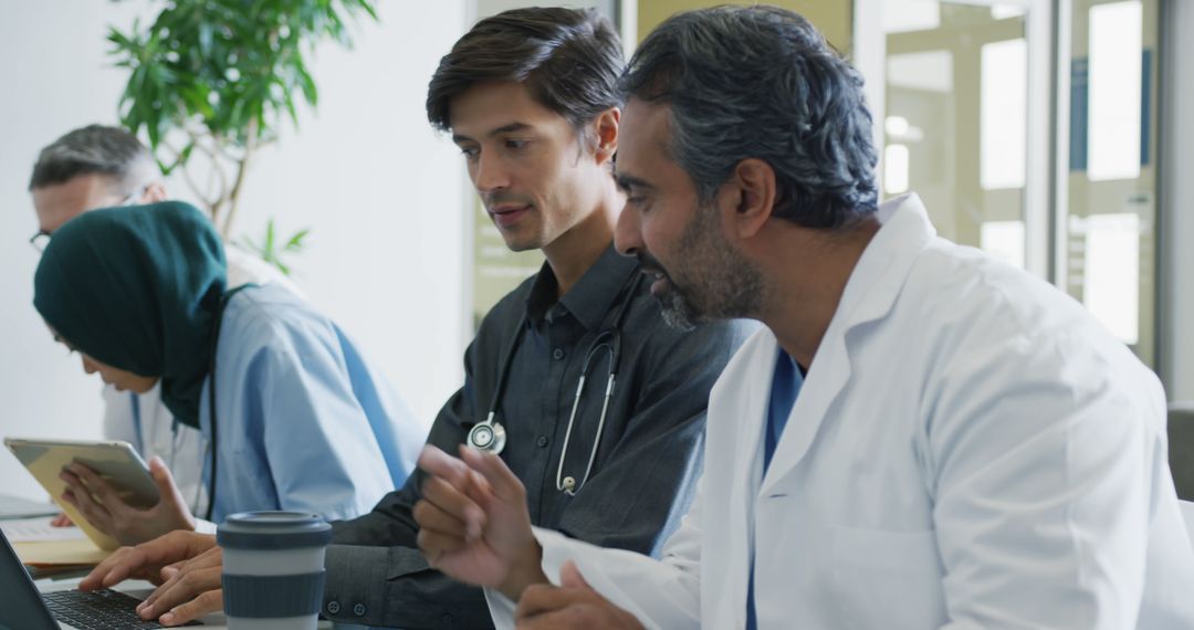 Diverse Medical Professionals Collaborating at Workdesk - Free Images, Stock Photos and Pictures on Pikwizard.com