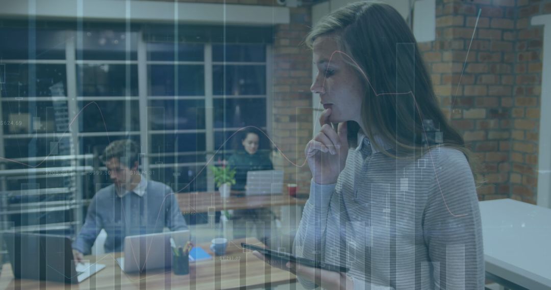 Businesswoman Analyzing Data in Office with Digital Interface