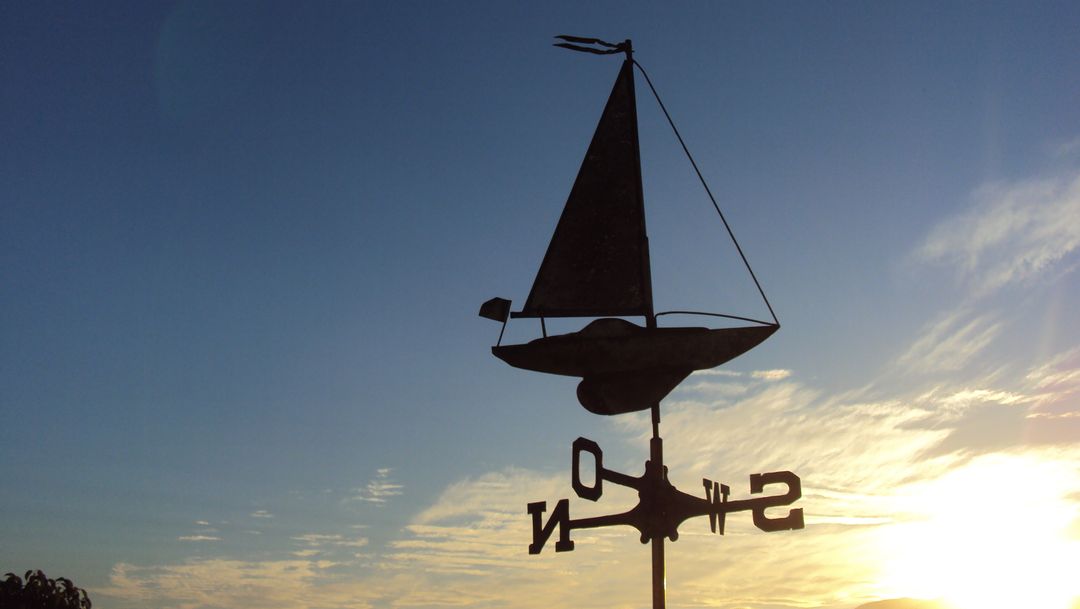 Sailboat Weathervane Against Sunset Sky - Free Images, Stock Photos and Pictures on Pikwizard.com