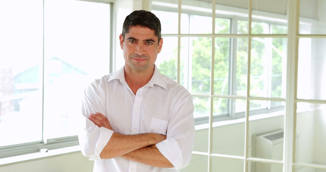 Confident Businessman Standing in Bright Modern Office - Free Images, Stock Photos and Pictures on Pikwizard.com