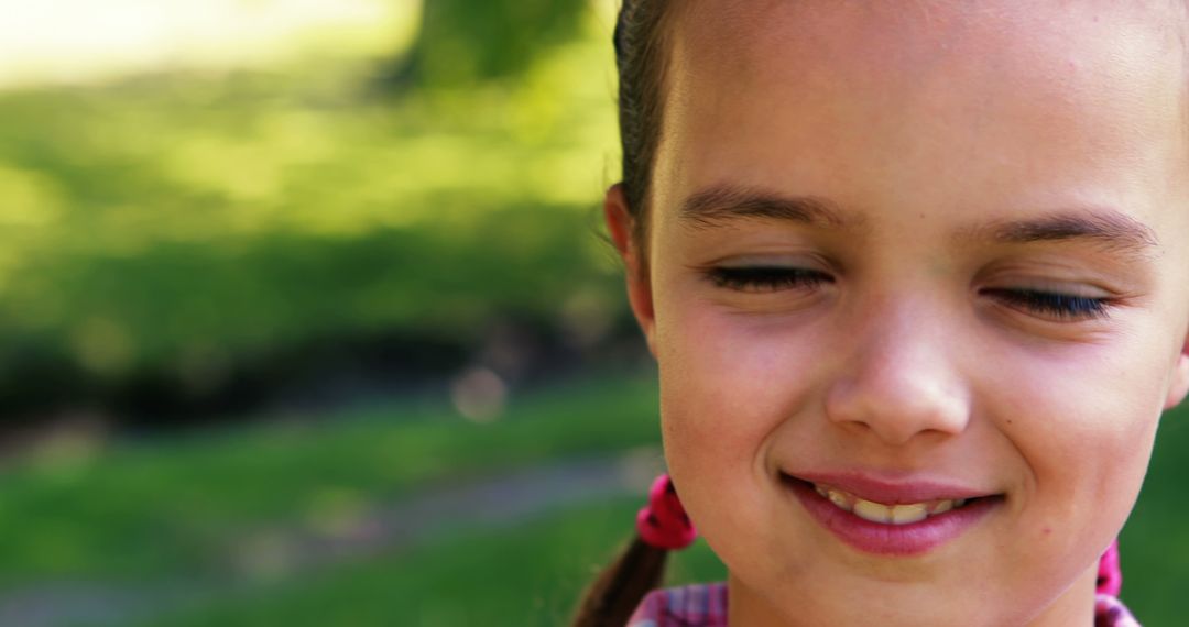 Close-up of Smiling Girl with Pigtails in Outdoor Landscape - Free Images, Stock Photos and Pictures on Pikwizard.com