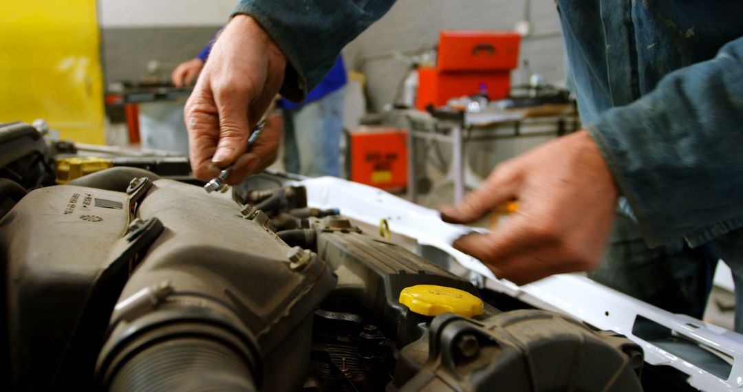 Mechanic Adjusting Engine Components in Auto Repair Shop - Free Images, Stock Photos and Pictures on Pikwizard.com