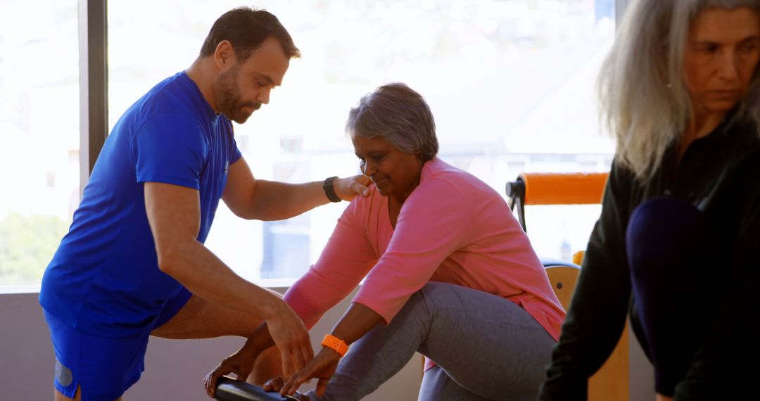 Personal Trainer Guiding Senior Woman During Exercise - Free Images, Stock Photos and Pictures on Pikwizard.com