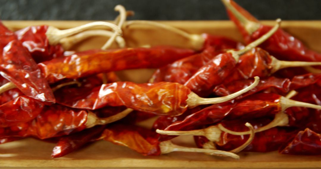 Dried chili pepper in wooden tray on black background 4k - Free Images, Stock Photos and Pictures on Pikwizard.com