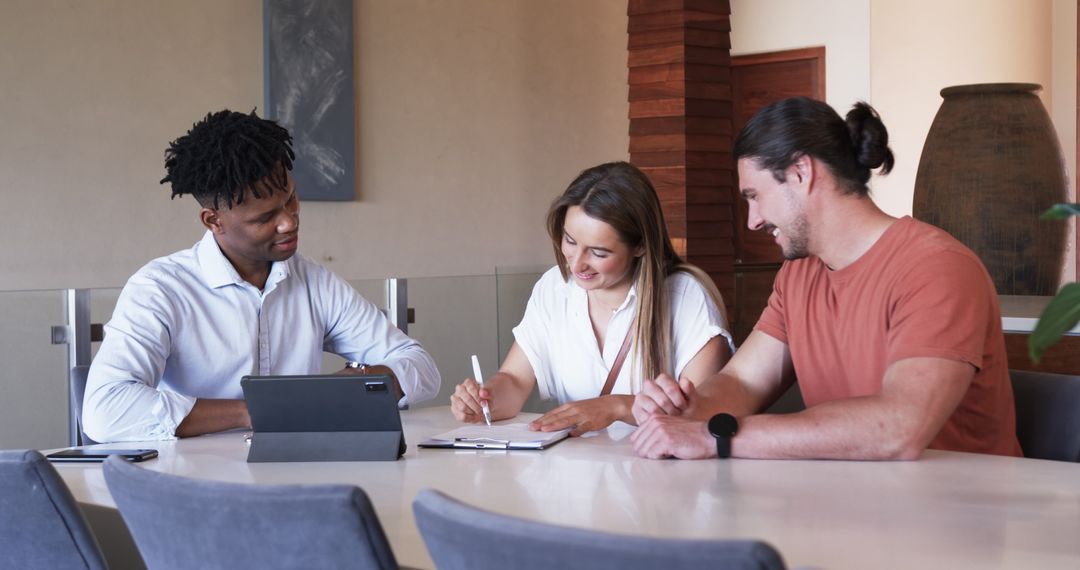 Diverse Group Brainstorming Ideas with Tablet in Modern Office