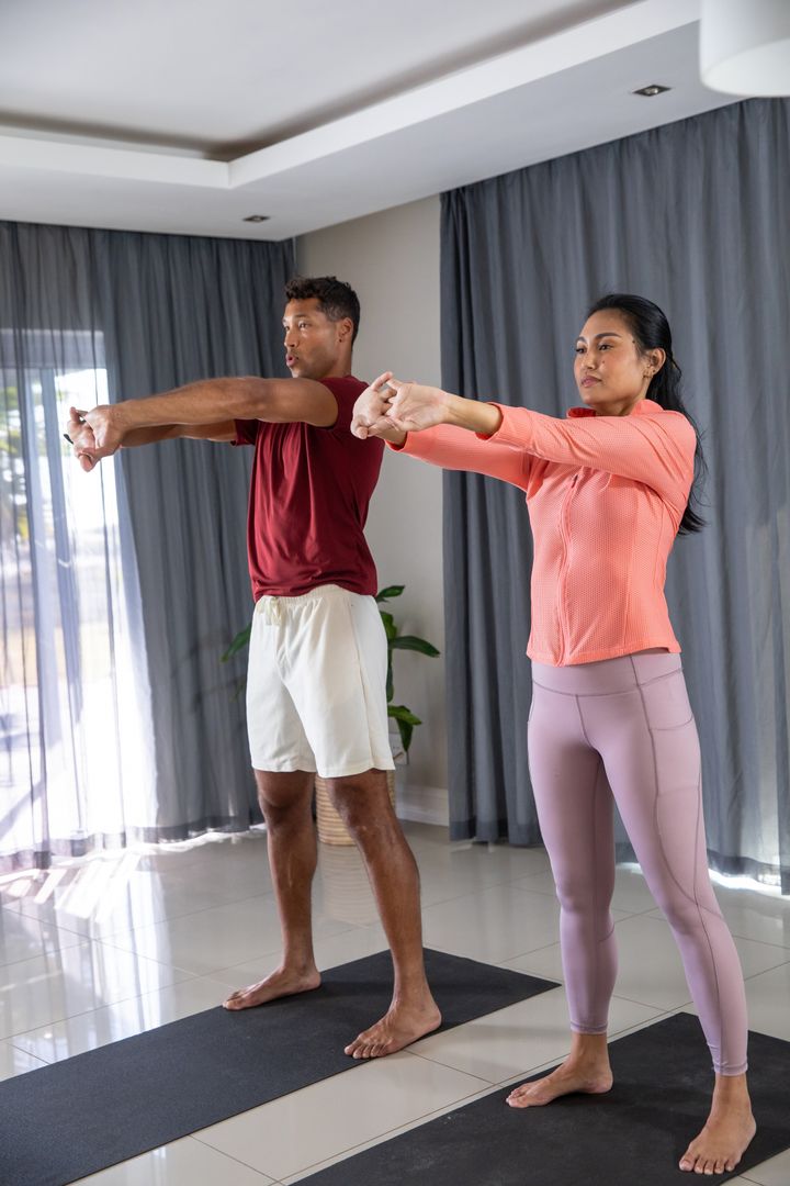 Diverse Couple Practicing Fitness Exercises Together at Home