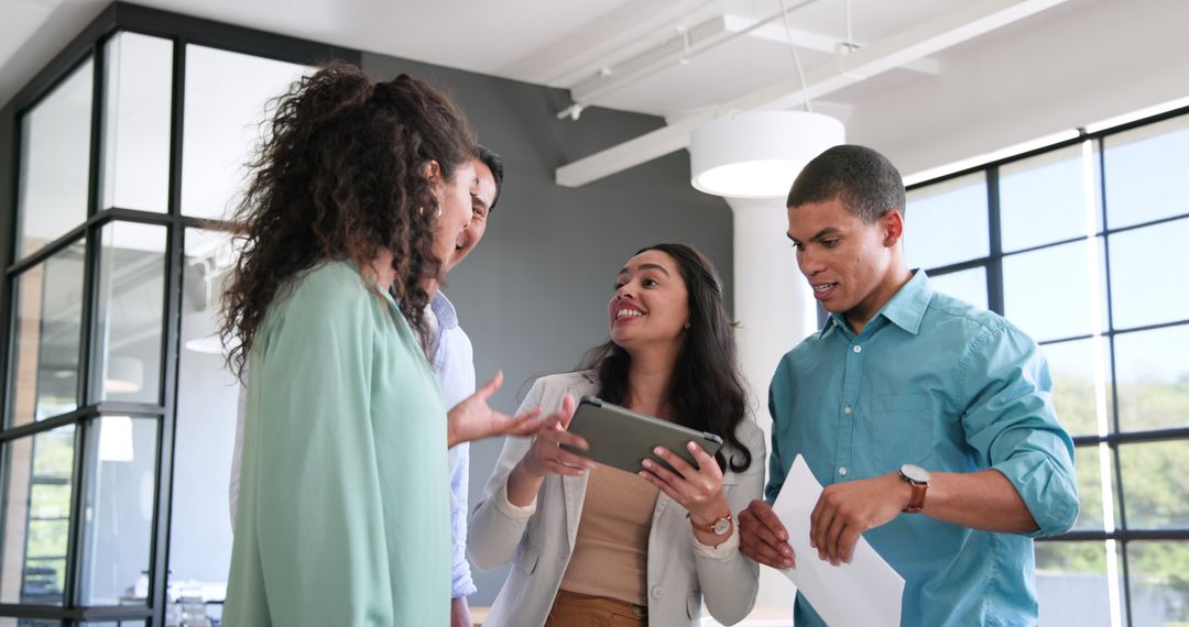 Diverse Team Collaborating and Celebrating Success with Tablet