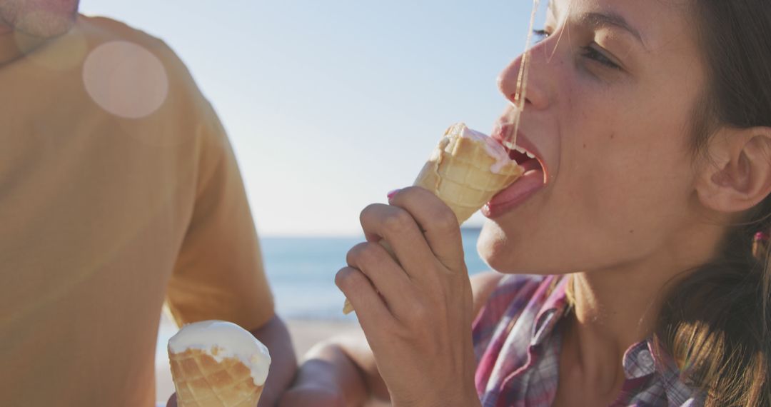 Woman Enjoying Ice Cream Cone at the Beach on Sunny Day - Free Images, Stock Photos and Pictures on Pikwizard.com