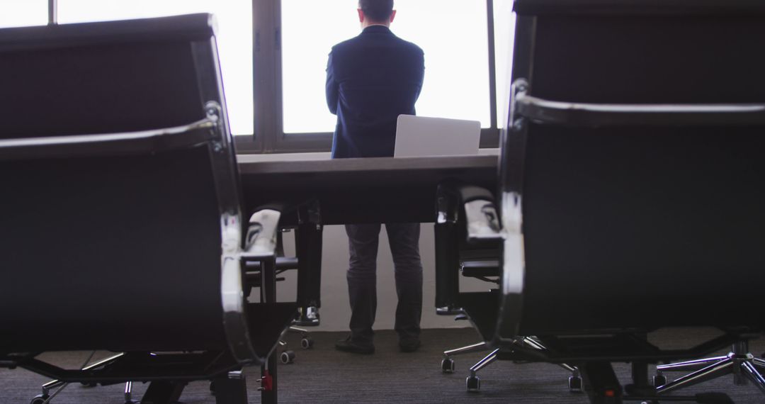 Business Executive Standing at Window in Modern Office - Free Images, Stock Photos and Pictures on Pikwizard.com