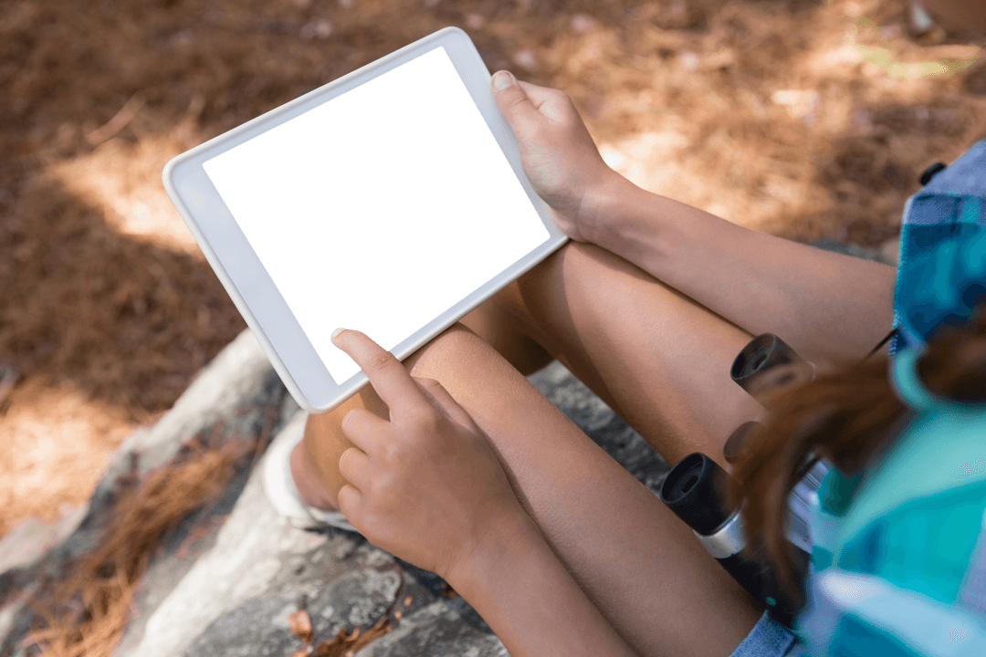 Girl Holding Tablet in Forest with Black Screen for App Design