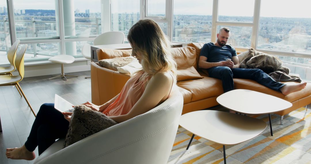 Couple Relaxing in Modern Apartment Living Room - Free Images, Stock Photos and Pictures on Pikwizard.com