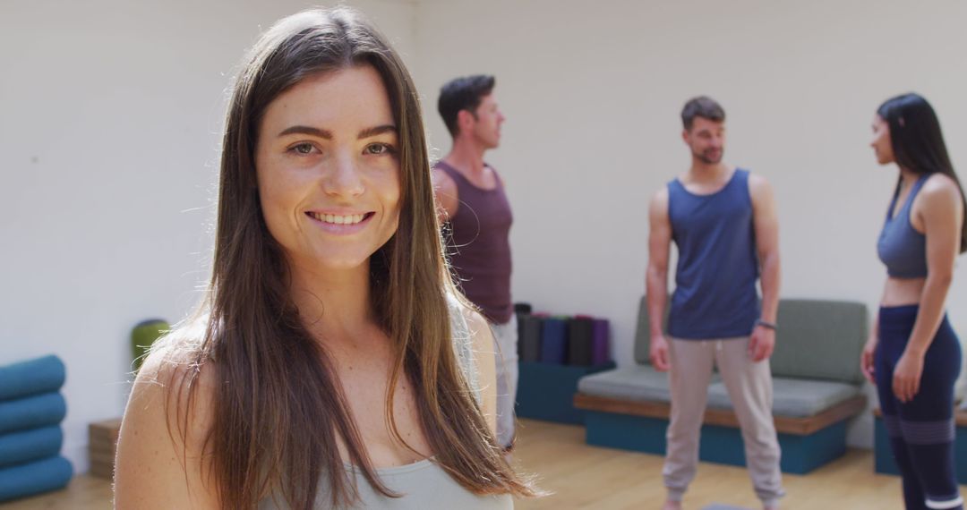 Happy Woman in Yoga Class with Diverse Group in Background
