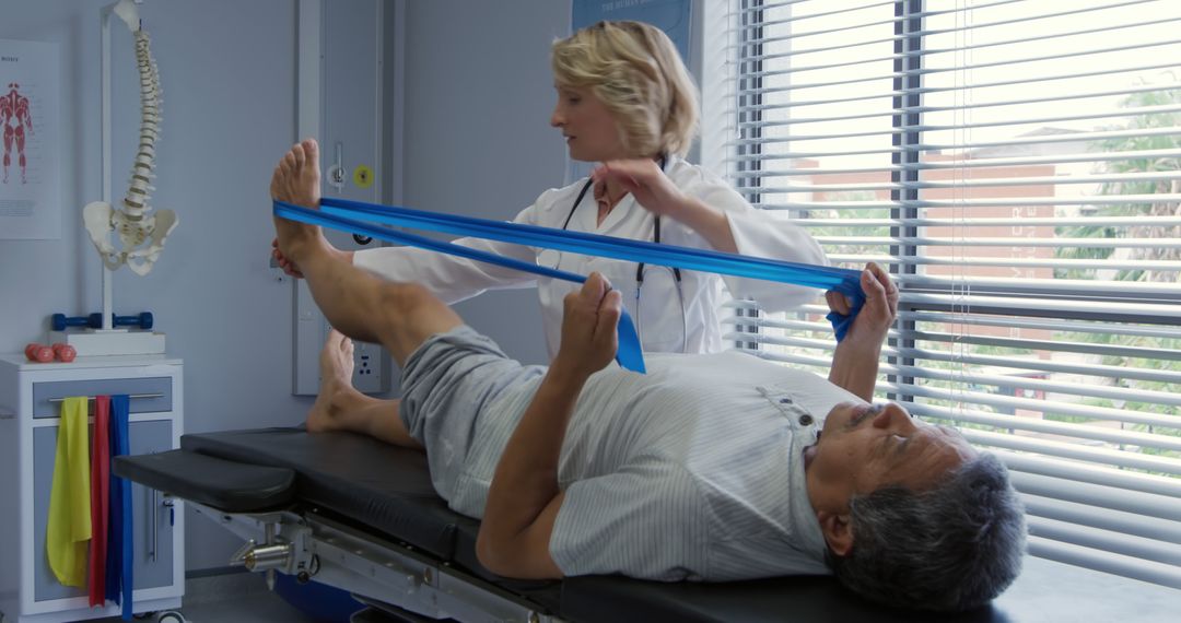 Physical Therapist Assisting Senior with Resistance Band Exercises - Free Images, Stock Photos and Pictures on Pikwizard.com