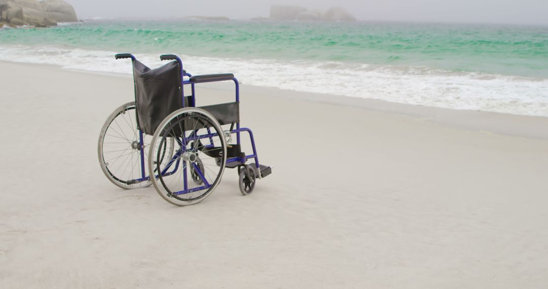 Empty wheelchair at beach on a sunny day - Free Images, Stock Photos and Pictures on Pikwizard.com
