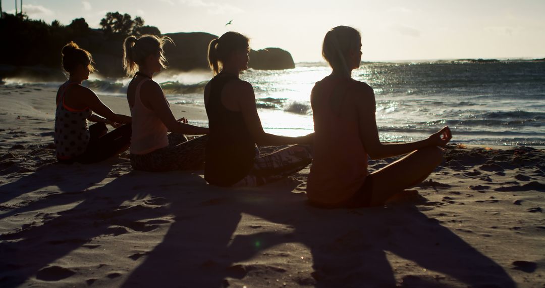 Women Practicing Yoga at Beach Sunset, Embracing Tranquility - Free Images, Stock Photos and Pictures on Pikwizard.com