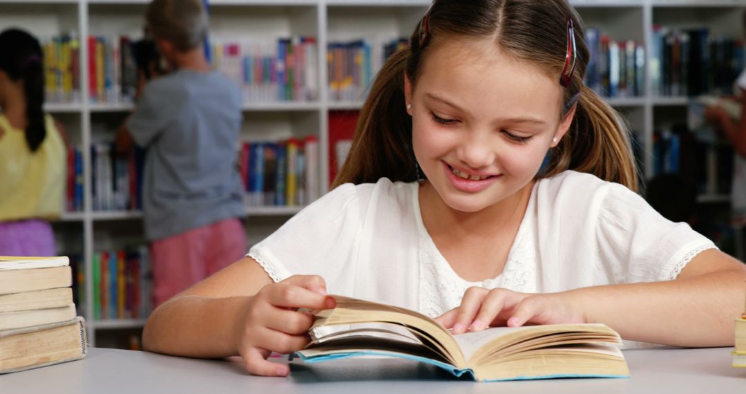 Schoolgirl Reading and Engaging with Books in Library - Free Images, Stock Photos and Pictures on Pikwizard.com