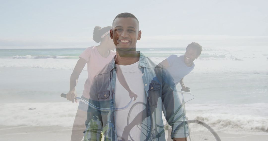 Man Smiling on Scenic Beach with Friends Cycling in Background