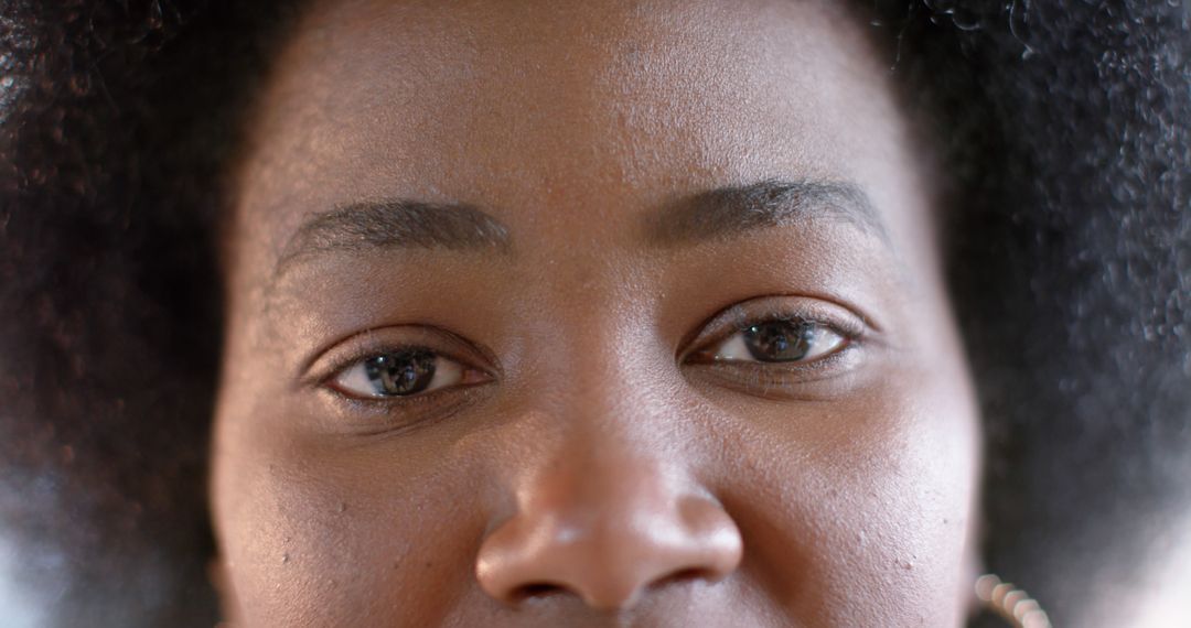 Close-up View of Young Woman with Natural Hair Looking into Camera - Free Images, Stock Photos and Pictures on Pikwizard.com