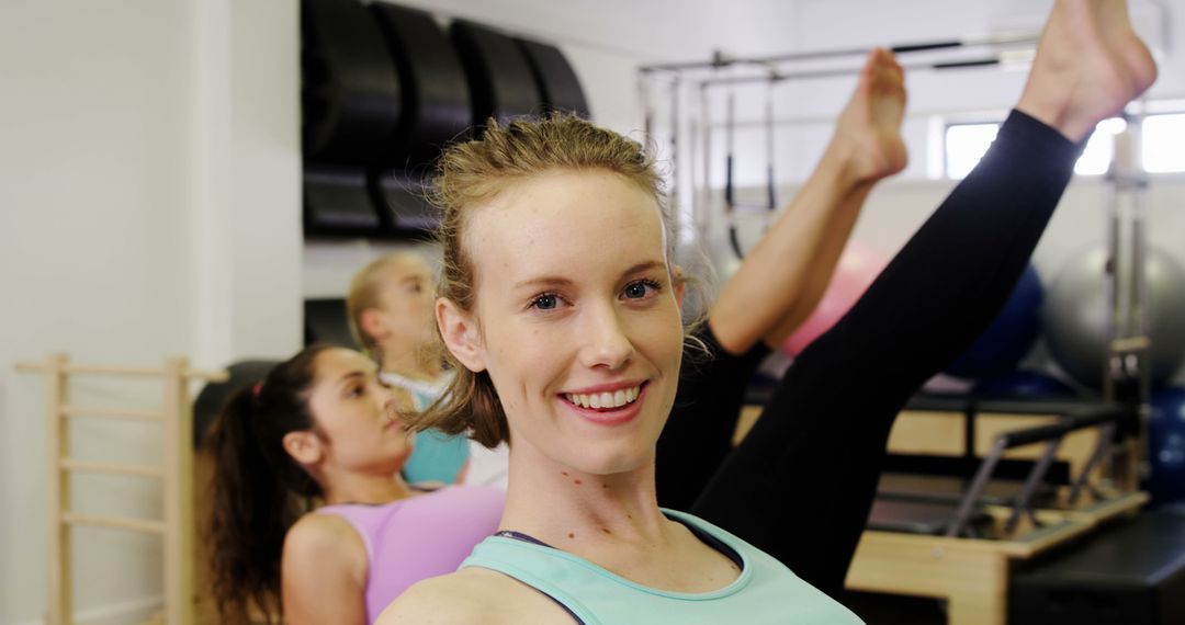 Women Smiling During Pilates Class at Fitness Studio - Free Images, Stock Photos and Pictures on Pikwizard.com