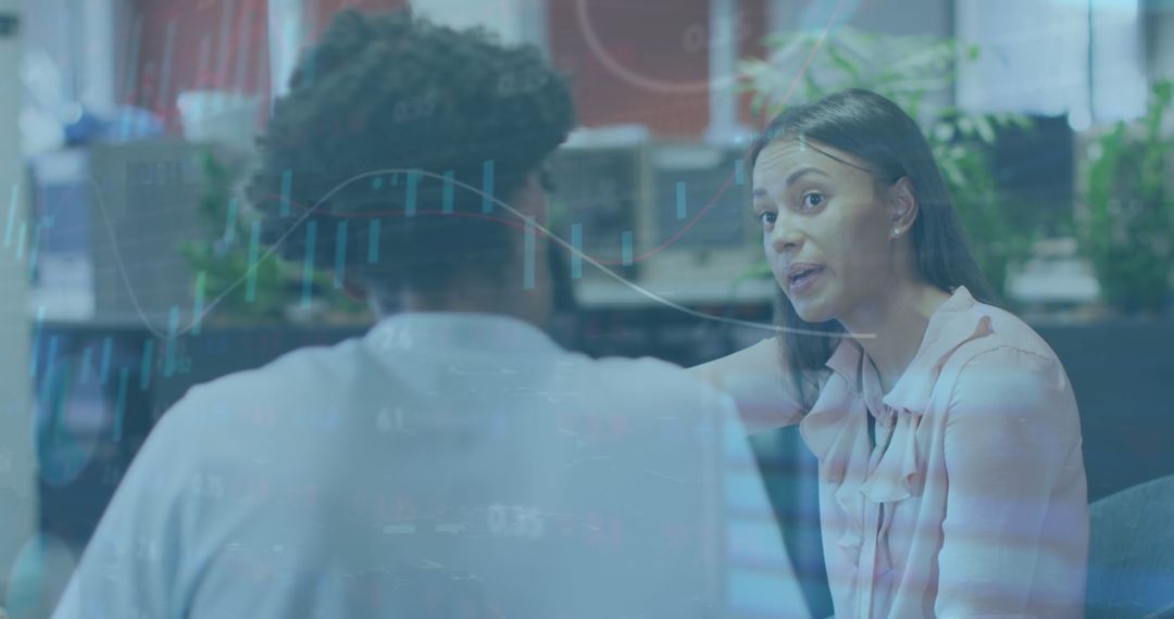 Coworkers Analyzing Financial Data in Modern Office