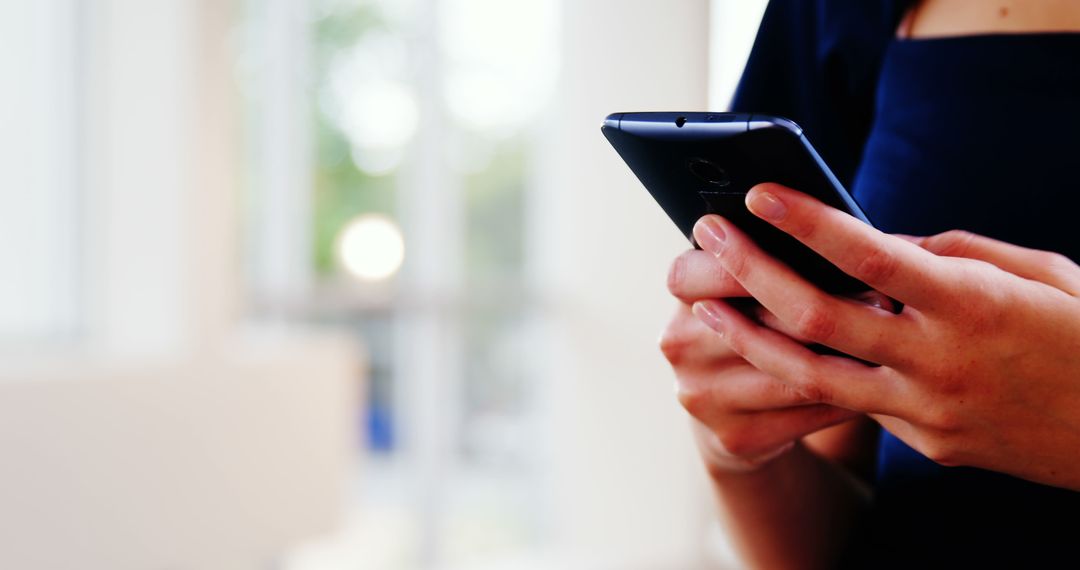 Close-Up of Person Using Smartphone in Bright Room - Free Images, Stock Photos and Pictures on Pikwizard.com