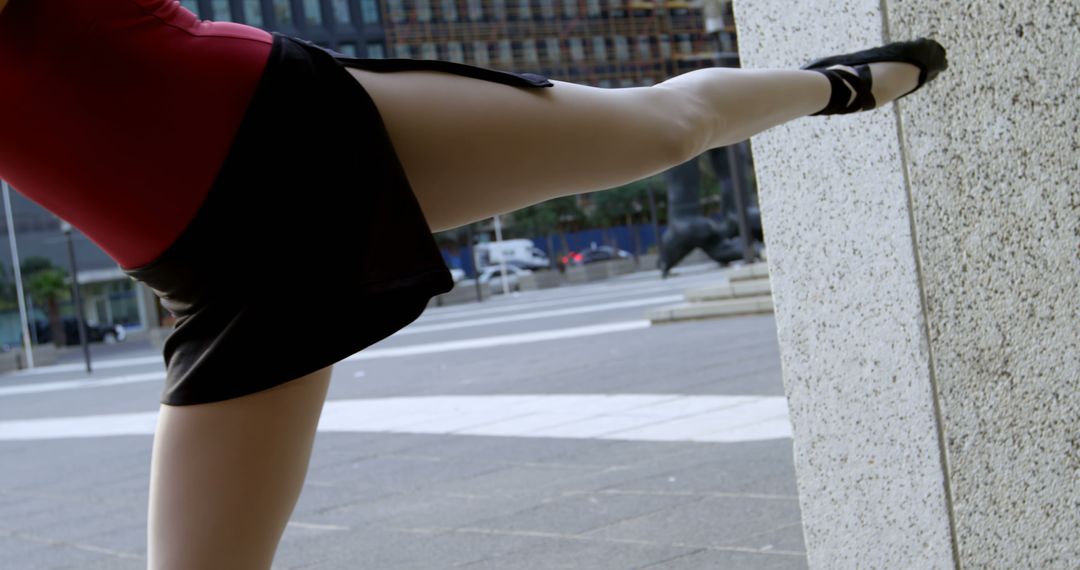 Ballet Dancer Stretching Leg on Urban Wall - Free Images, Stock Photos and Pictures on Pikwizard.com