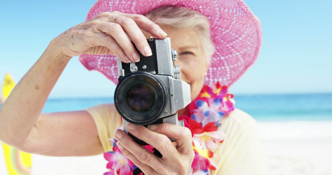 Senior woman taking picture on the beach - Free Images, Stock Photos and Pictures on Pikwizard.com