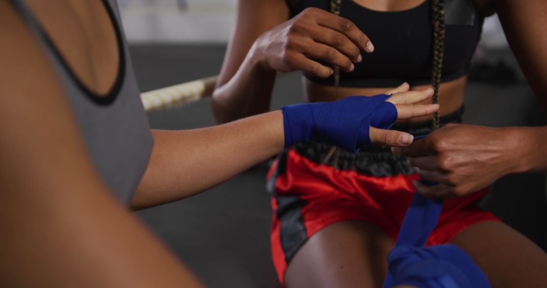 Female Boxer Wrapping Hands with Blue Hand Wraps in Gym - Free Images, Stock Photos and Pictures on Pikwizard.com