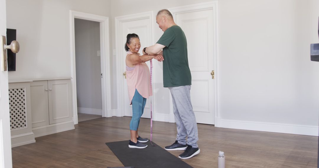 Senior Asian Couple Exercising Together Enjoying Home Workout Routine