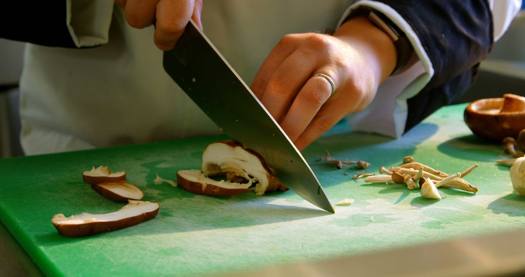 Chef Slicing Mushrooms on Green Cutting Board in Kitchen - Free Images, Stock Photos and Pictures on Pikwizard.com