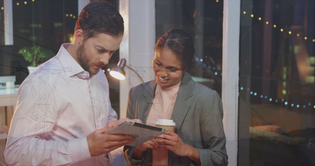 Business Team Analyzing Data on Tablet in Night Office