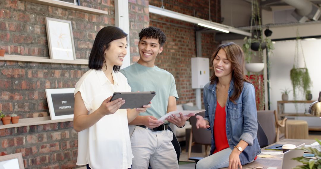 Diverse Coworkers Collaborating in Modern Office Using Technology