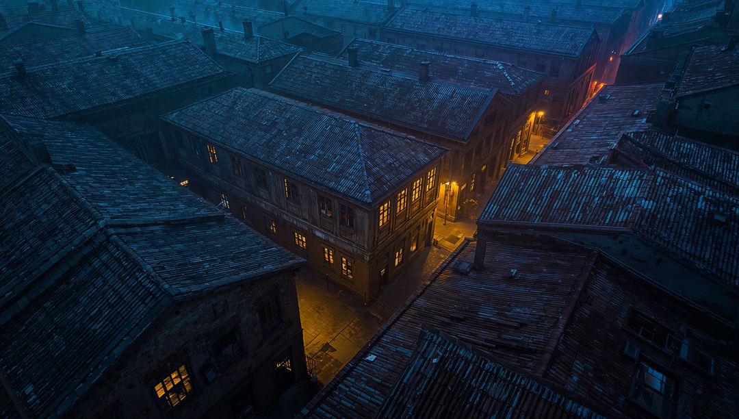 Atmospheric Night View of Historic Rooftops and Lit Alley