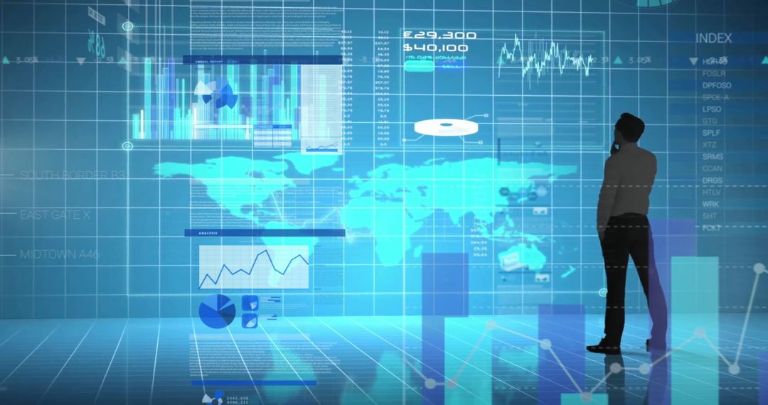 Businessman Analyzing Financial Data on Transparent Screens